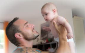 A father singing to his baby