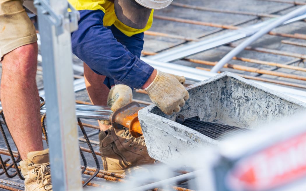 A person in protective gear working on a construction site.