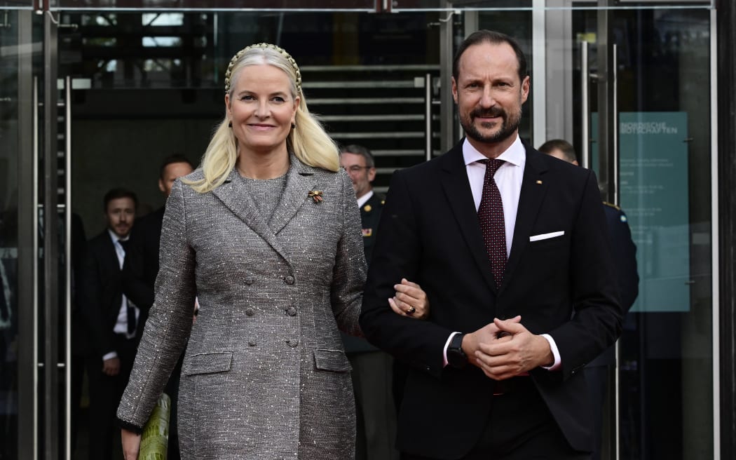 (FILES) Crown Princess Mette-Marit of Norway and Crown Prince Haakon of Norway pose upon arrival for a reception to celebrate the 25th anniversary of the Nordic embassy complex with other representatives from the five Nordic countries and Germany in Berlin, Germany, on October 21, 2024. As her son prepares to stand trial for rape, Princess Mette-Marit, future Queen of Norway, is embroiled in another scandal, with new Epstein documents revealing an unexpected closeness to the American sex offender. The name of Mette-Marit, wife of Crown Prince Haakon, appears multiple times — at least 1,000 times, according to the Norwegian newspaper Verdens Gang (VG)—in the millions of pages released on January 30, 2026 by the US Department of Justice. (Photo by John MACDOUGALL / AFP)