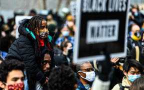 People react as the verdict is announced in the trial of former police officer Derek Chauvin outside the Hennepin County Government Center in Minneapolis, Minnesota on April 20, 2021.