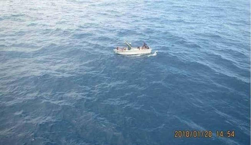 The ferry's boat with the seven survivors approaching the fishing vessel.