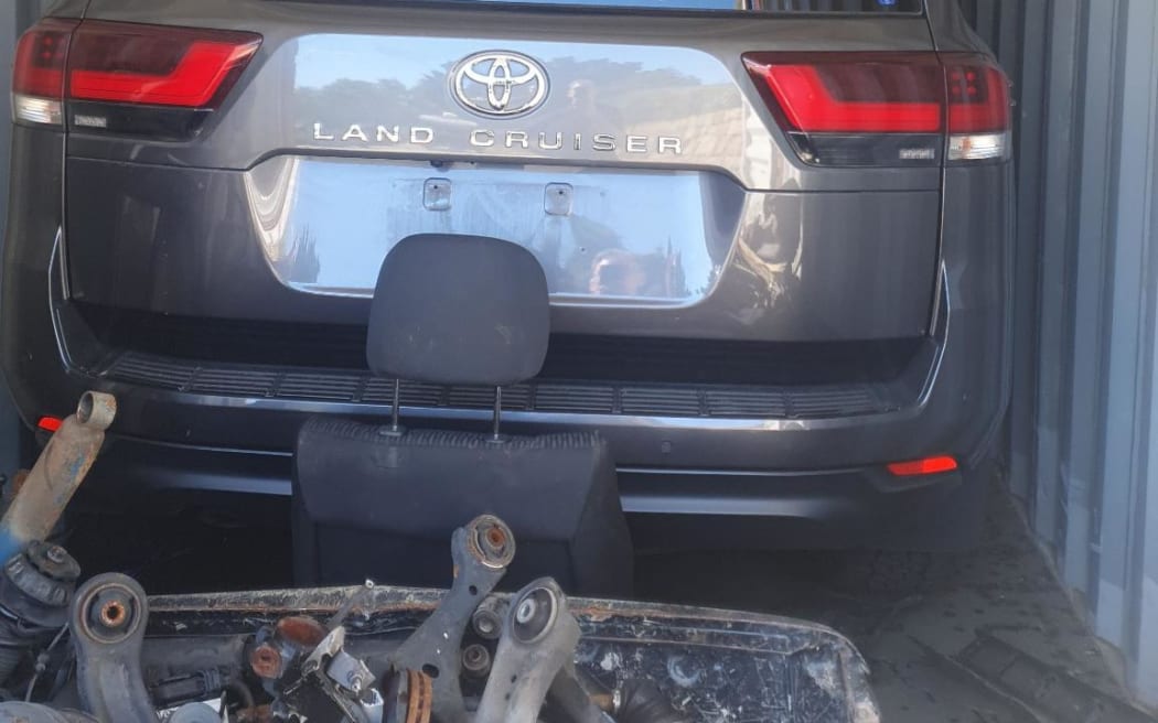 Police found two allegedly stolen Toyota LandCruisers concealed by other car parts in shipping containers. (Supplied: Queensland Police Service)