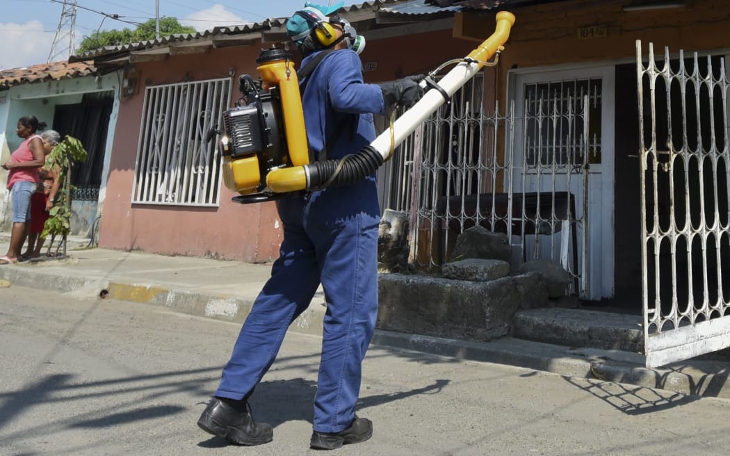 A health worker fumigates against the Aedes Aegypti mosquito in Cali, Colombia.