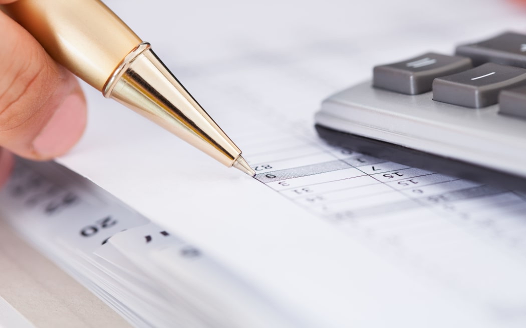Cropped image of businessman checking expense in office