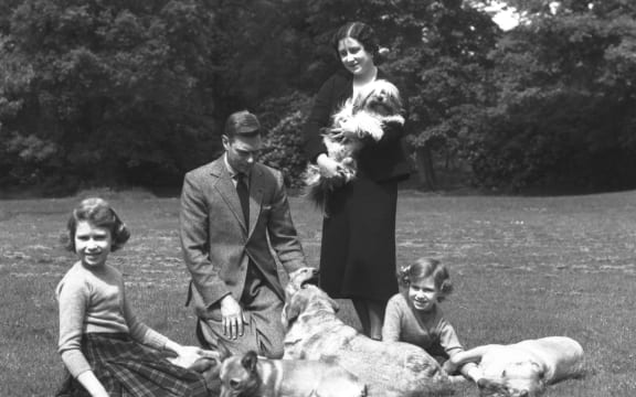 June 1936:  King George VI and Queen Elizabeth (Queen Elizabeth the Queen Mother) with the Royal Princesses Elizabeth (later Queen Elizabeth II) and Margaret (1930 - 2002) in the grounds of Windsor Castle with four dogs.  (Photo by Lisa Sheridan/Studio Lisa/Getty Images)