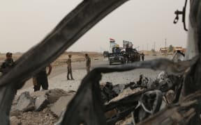 Iraqi troops on the Mosul-Erbil highway 
as part of the operation to drive IS militants from Mosul.