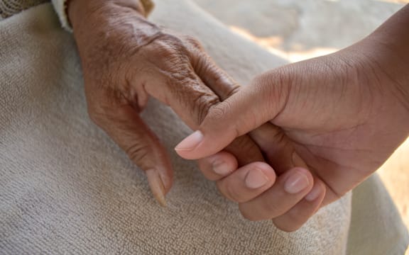 Close up granddaughter takes care of the health sick grandmother at home by holding hands. Lifestyle support the love of the family.