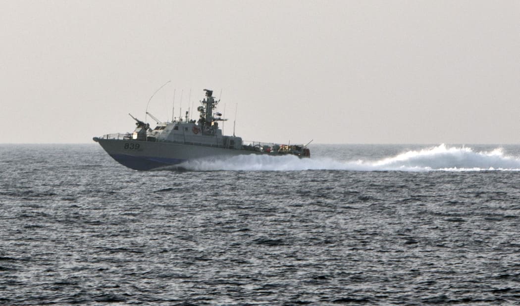An armed Israeli navy vessel patrols along the coast of the Gaza Strip.