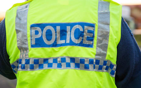 A police officer outside a cordon in South Auckland.