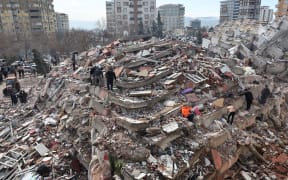 Civilians look for survivors under the rubble of collapsed buildings in Kahramanmaras, close to the quake's epicentre, the day after a 7.8-magnitude earthquake struck Türkiye on February 7, 2023.