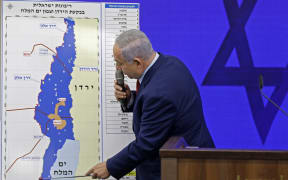 Israeli Prime Minister Benjamin Netanyahu points at a map of the Jordan Valley as he gives a statement in Ramat Gan, near the Israeli coastal city of Tel Aviv, on September 10, 2019.
