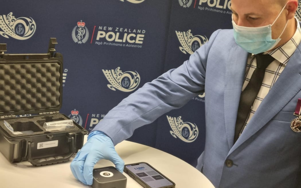 Police demonstrate the new Lumi drug scanning tool, which is being rolled out for use nationwide, following a six-month pilot.