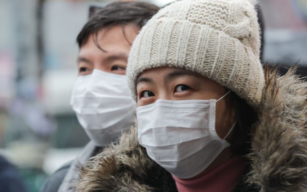 Flushing, Queens, New York, USA, January 25, 2020 - Mask People afraid of the coronavirus During the Queens Lunar New Year Parade in Flushing Along with Thousands of Chinese Immigrants and Parade Goers.