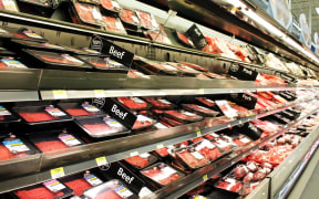 Meat and poultry products on shelves in a supermarket