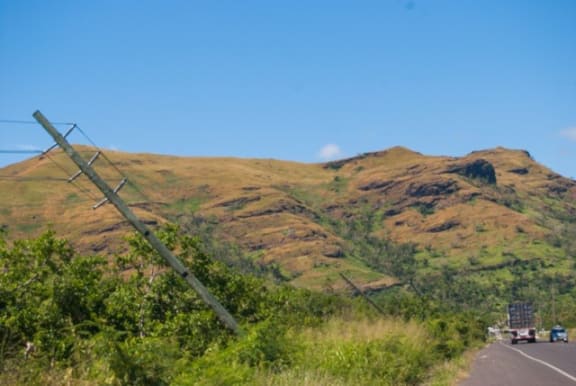 Fijian power poles sit at 45-degree angles after Cyclone Winston.