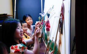 Young children participate in a Chinese shadow puppetry workshop ahead of Lunar New Year celebrations.