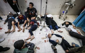 Members of the al-Qedra family, who were injured during Israeli bombardment, receive treatment at Nasser hospital in Khan Yunis on the southern Gaza Strip on 16 December, 2023.