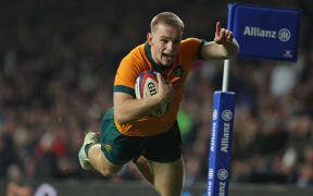Australia's Max Jorgensen dives over the line to score their late winning try against England at Twickenham.