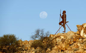 Aboriginal figure with full moon, Cue, Murchison, Western Australia | usage worldwide