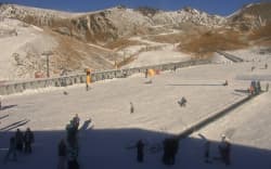 A still from The Remarkables snow cam shows brown peaks and very little snow.
