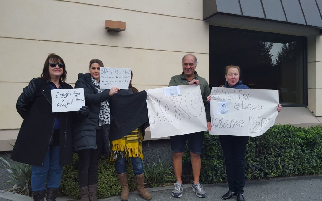 A handful of protesters outside Queenstown's courthouse this morning.