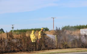 Firefighters fighting a series of fires along the railway line near Kirwee, west of Christchurch.