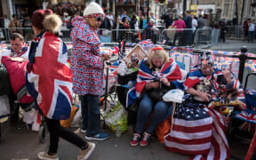 Royal fans wait along the proposed route of the carriage procession for Britain's Prince Harry and US actress Meghan Markle, in Windsor.