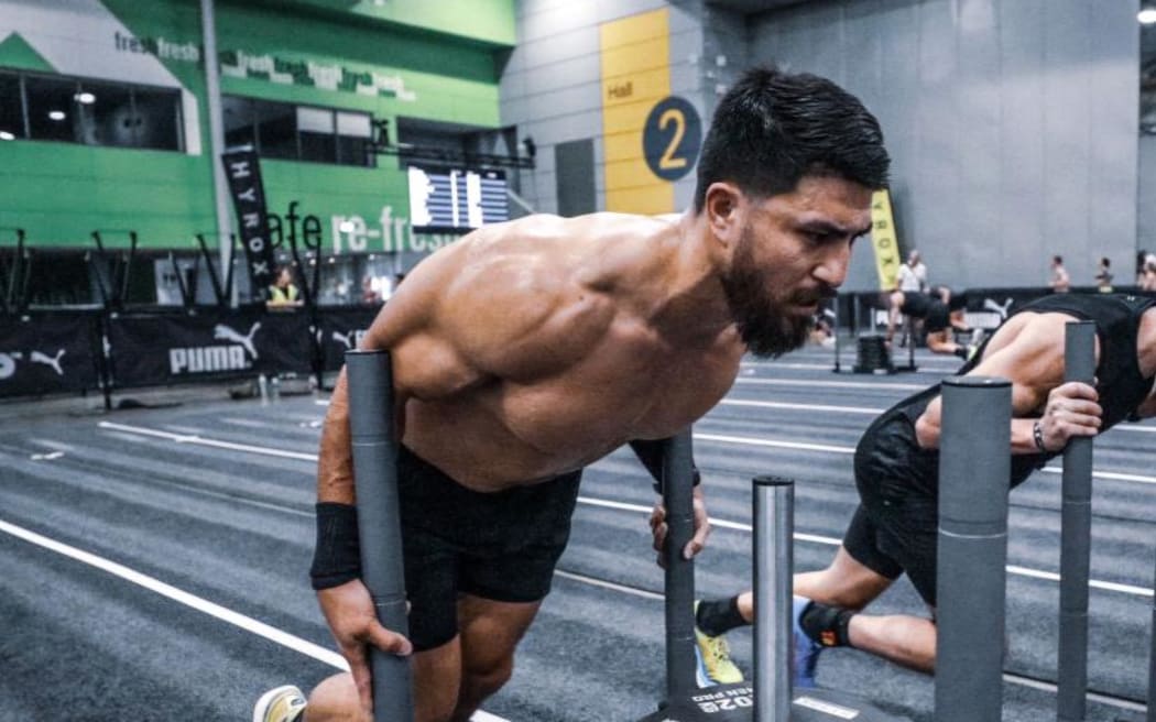 Abbas Nazari doing the sled push at a Hyrox competition.