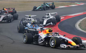 Liam Lawson of New Zealand driving the (30) Visa Cash App Racing Bulls VCARB 03 RB Ford leads Carlos Sainz of Spain driving the (55) Williams FW48 Mercedes and Fernando Alonso of Spain driving the (14) Aston Martin F1 Team AMR26 Honda at the start during the F1 Grand Prix of China.