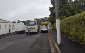 Contractors working on the road to clean up the debris in Dunedin left over after storm Fehi passed through.