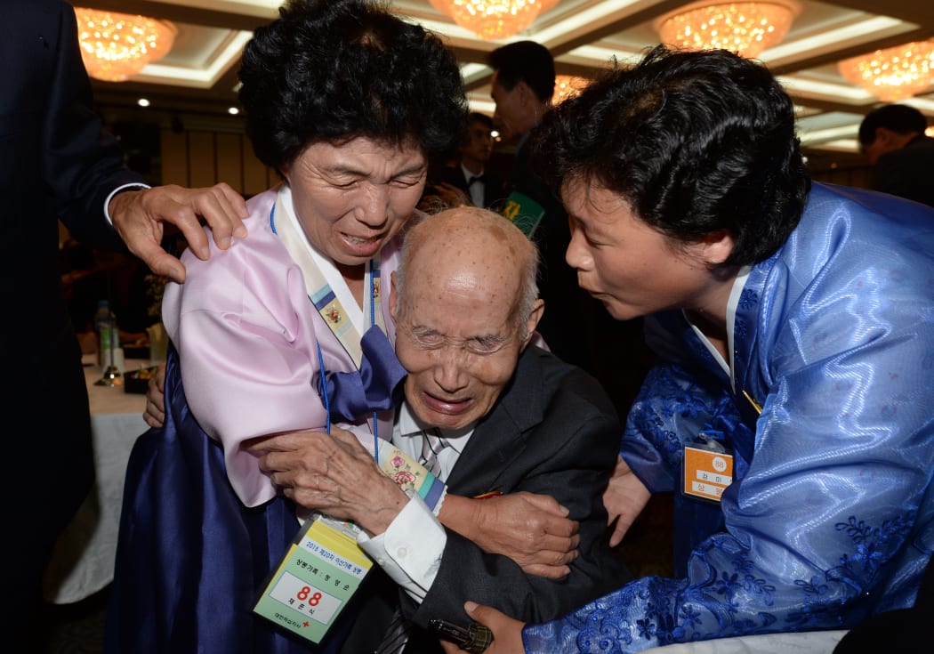North Korean Chae Hun-Sik, 88, centre, embraces his South Korean relative.