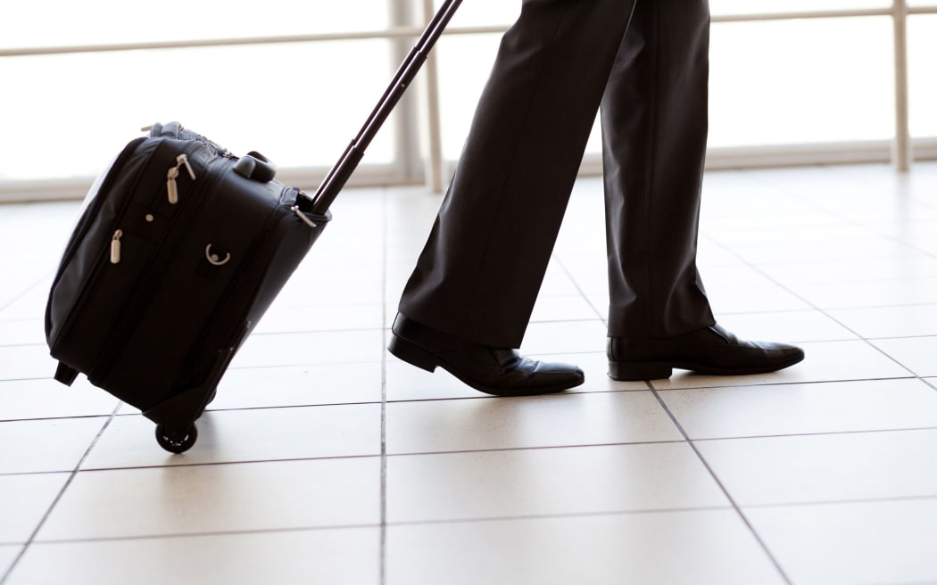 12884130 - silhouette of businessman walking in airport