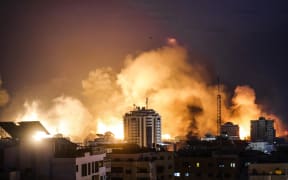 A fireball erupts during Israeli bombardment of Gaza City on 9 October 2023. Israel imposed a total siege on the Gaza Strip on October 9 and cut off the water supply as it kept bombing targets in the crowded Palestinian enclave in response to the Hamas surprise assault.