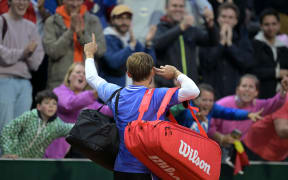 Belgium's David Goffin cheers spectators and celebrates after winning his men's singles match against France's Giovanni Mpetshi Perricard on day three of the French Open tennis tournament at the Roland Garros, 2024.