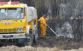 Firefighters dampen hot spots in Rolleston.