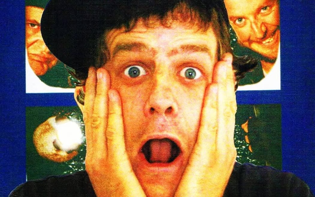 A poster imitating the cover of the film 'Home Alone.' DJ StickyFingaz is center frame, with hands on either side of his face, looking shocked. There are windows behind him with shady-looking figures, the villians from the home alone move. The border is blue, with red and white text above DJ StickyFingaz that says: 'FRIDAY 1ST APRIL - DRINK SPECIALS ALL NIGHT' below, a title in larger text saying: 'HOME ALONe' and underneath that title, smaller text saying: 'A NIGHT AT HOME BAR WITH DJ STICKYFINGAZ.'