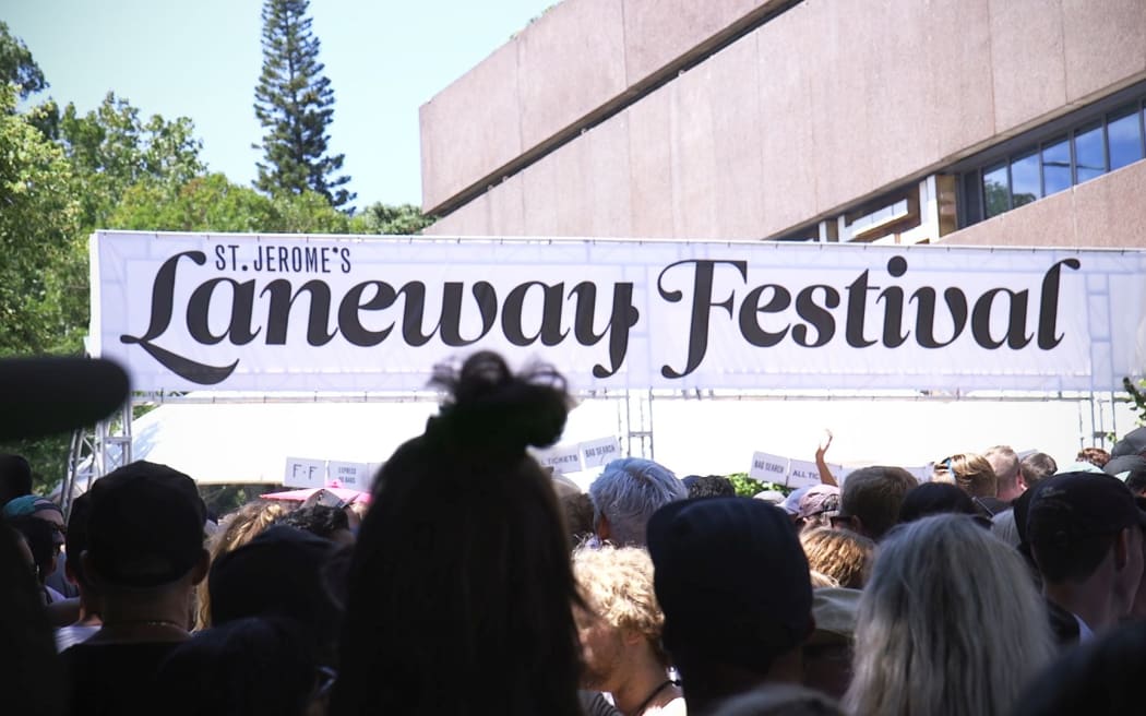 Patrons queue in the sun at the entrance to the Laneway Festival this afternoon.