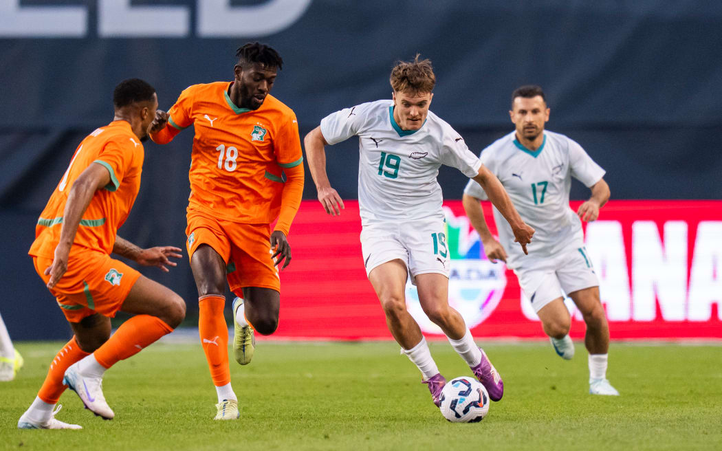 Ben Old #19 of New Zealand plays the ball against Ibrahim Sangare #18 of Cote d'Ivoire