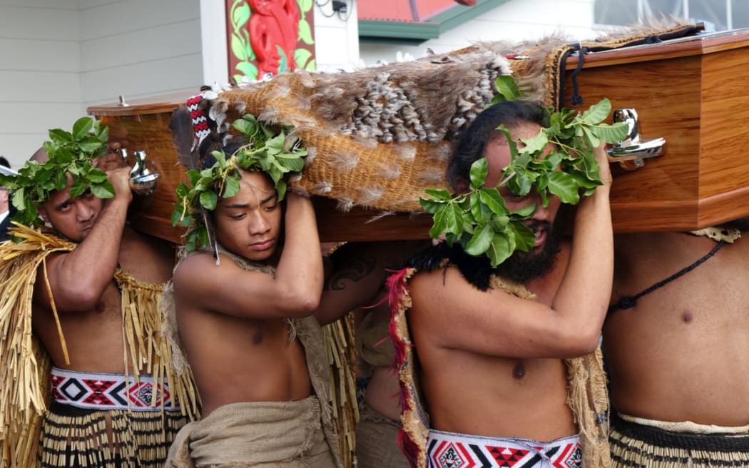 Sir Graham's coffin is carried from the marae.