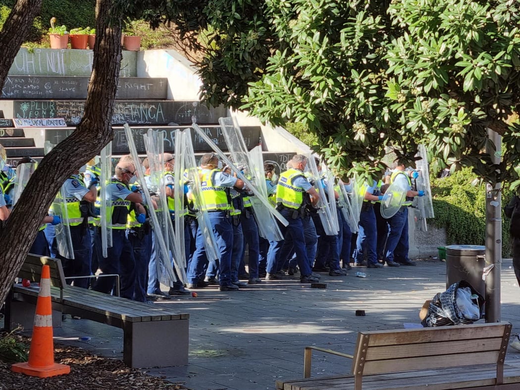 Police fending off missiles thrown by the protesters near Bowen Street.
