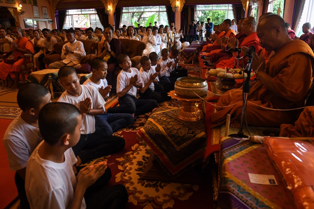 Members of the "Wild Boars" football team pay their respects to Buddhist monks during a ceremony to mark the end of their retreat as novice monks at the Wat Phra That Doi Tung temple in the Mae Sai district of Chiang Rai province on August 4, 2018.