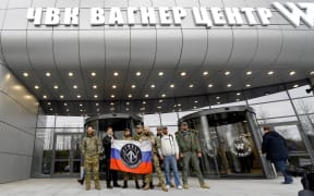 Members of Wagner Group stand outside new its new headquarters in St Petersburg in military camouflage , on November 4, 2022.