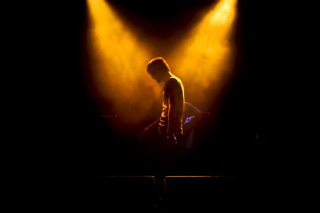 guy on stage under lights