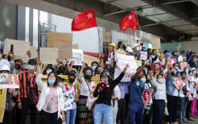 Myanmar protesters shout slogans and hold placards during a demonstration against military coup in Yangon, Myanmar