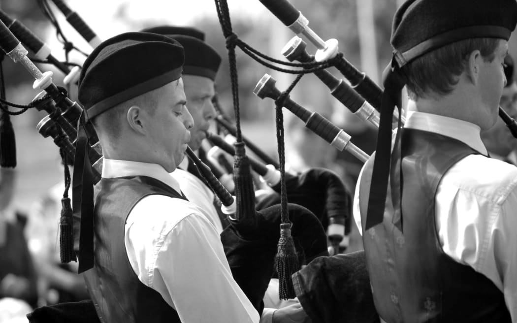 Young men playing the highland bagpipes