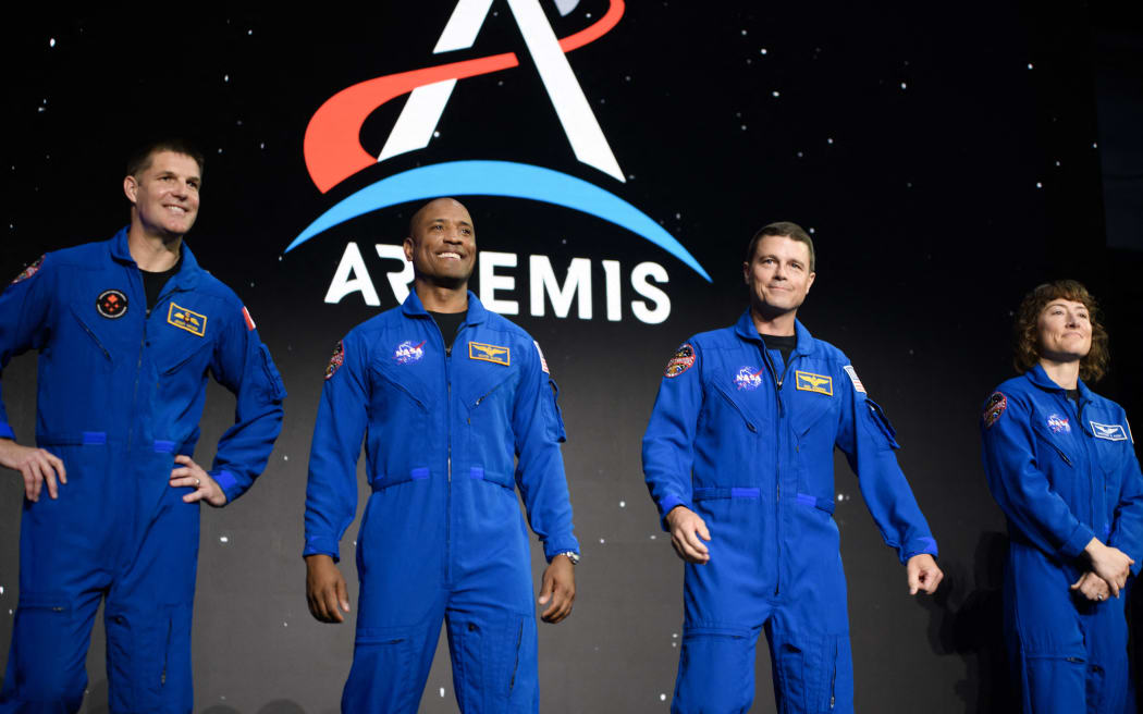 (L-R) Astronauts Jeremy Hansen, Victor Glover, Reid Wiseman and Christina Hammock Koch stand onstage after being selected for the Artemis II mission who will venture around the Moon during a news conference held by NASA and CSA at Ellington airport in Houston, Texas, on April 3, 2023. - Traveling aboard NASA’s Orion spacecraft during Artemis II, the mission is the first crewed flight test on the agency’s path to establishing a long-term scientific and human presence on the lunar surface. (Photo by Mark Felix / AFP)