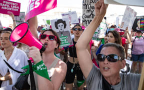 Abortion-rights activists march to the US Supreme Court on 24 June, 2023 in Washington, DC to mark the one year anniversary of a US Supreme Court decision which overturned Roe v Wade and erased federal protections for abortions.