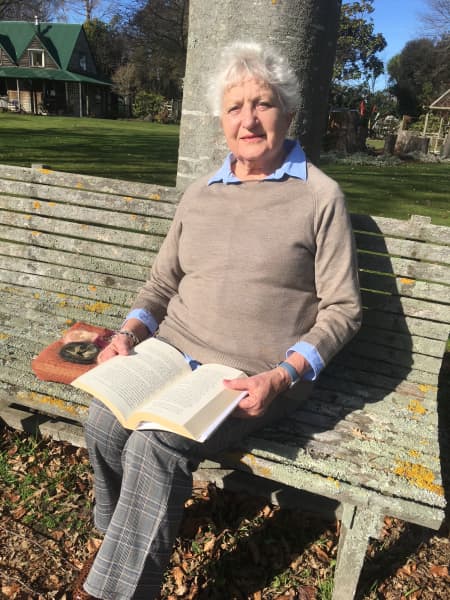 Annette Hill,85, enjoys reading in her garden. She has been a member of her group for half a century.