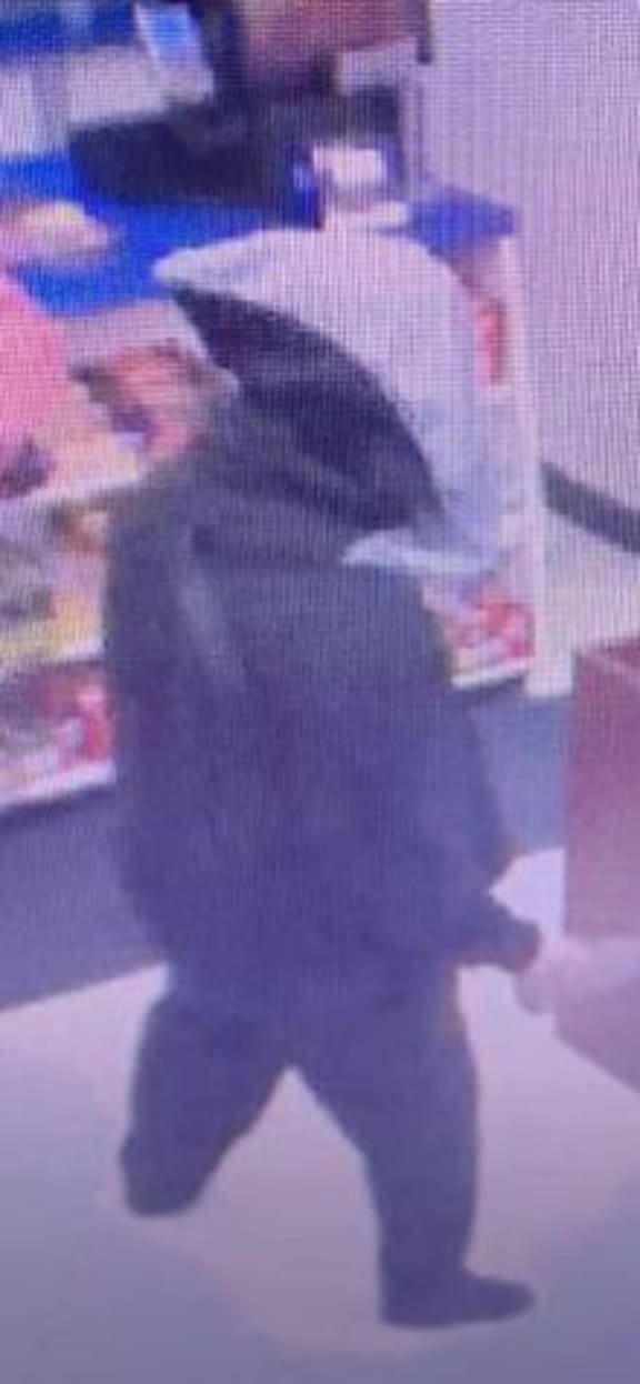Security footage shows the man who threatened staff and demanded money and cigarettes after breaking a glass case with a rock.