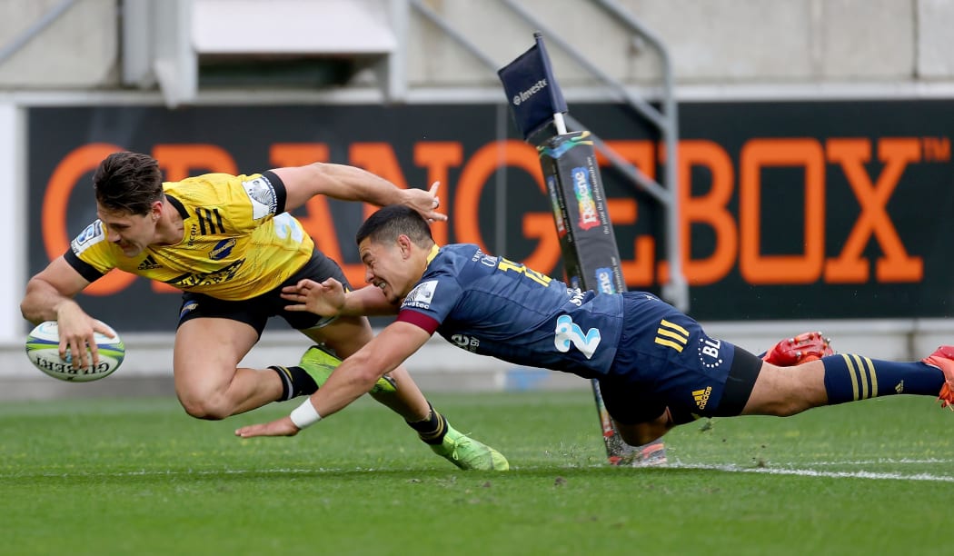 Hurricanes winger Kobus van Wyk scores in the tackle of Sio Tomkinson